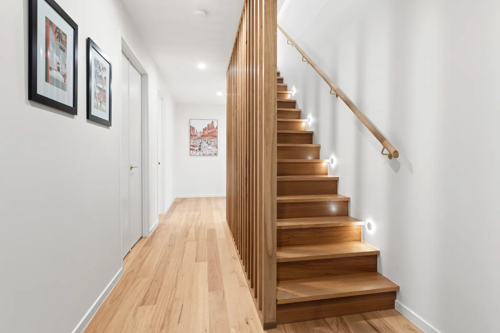 Organic Curves hallway with a timber staircase and soft lighting