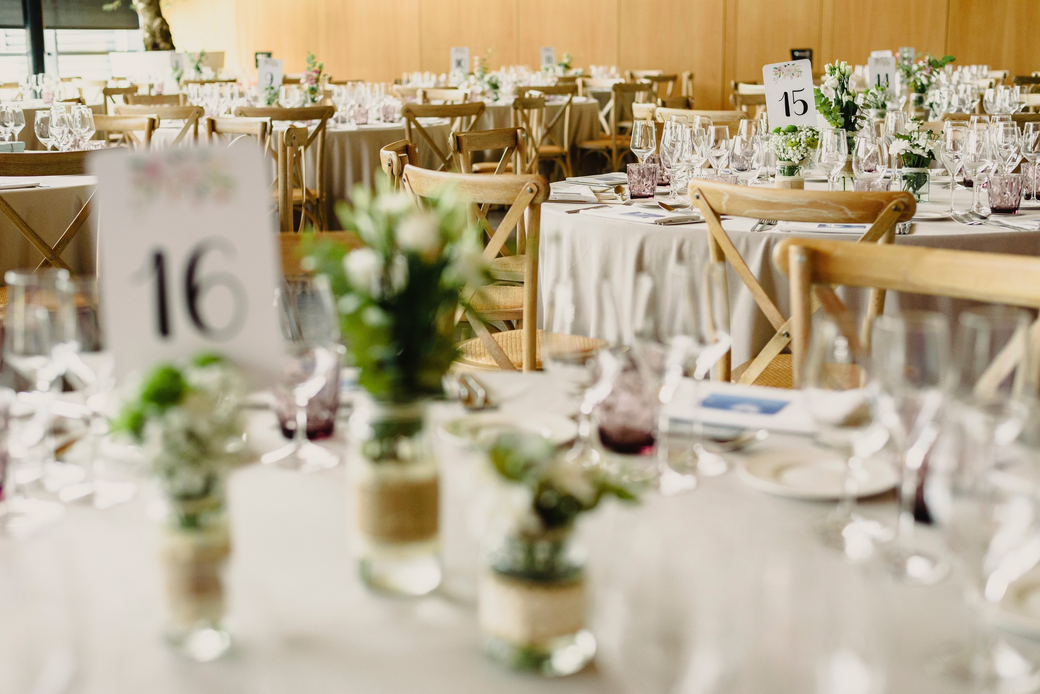 A reception table set with soft florals and warm timber