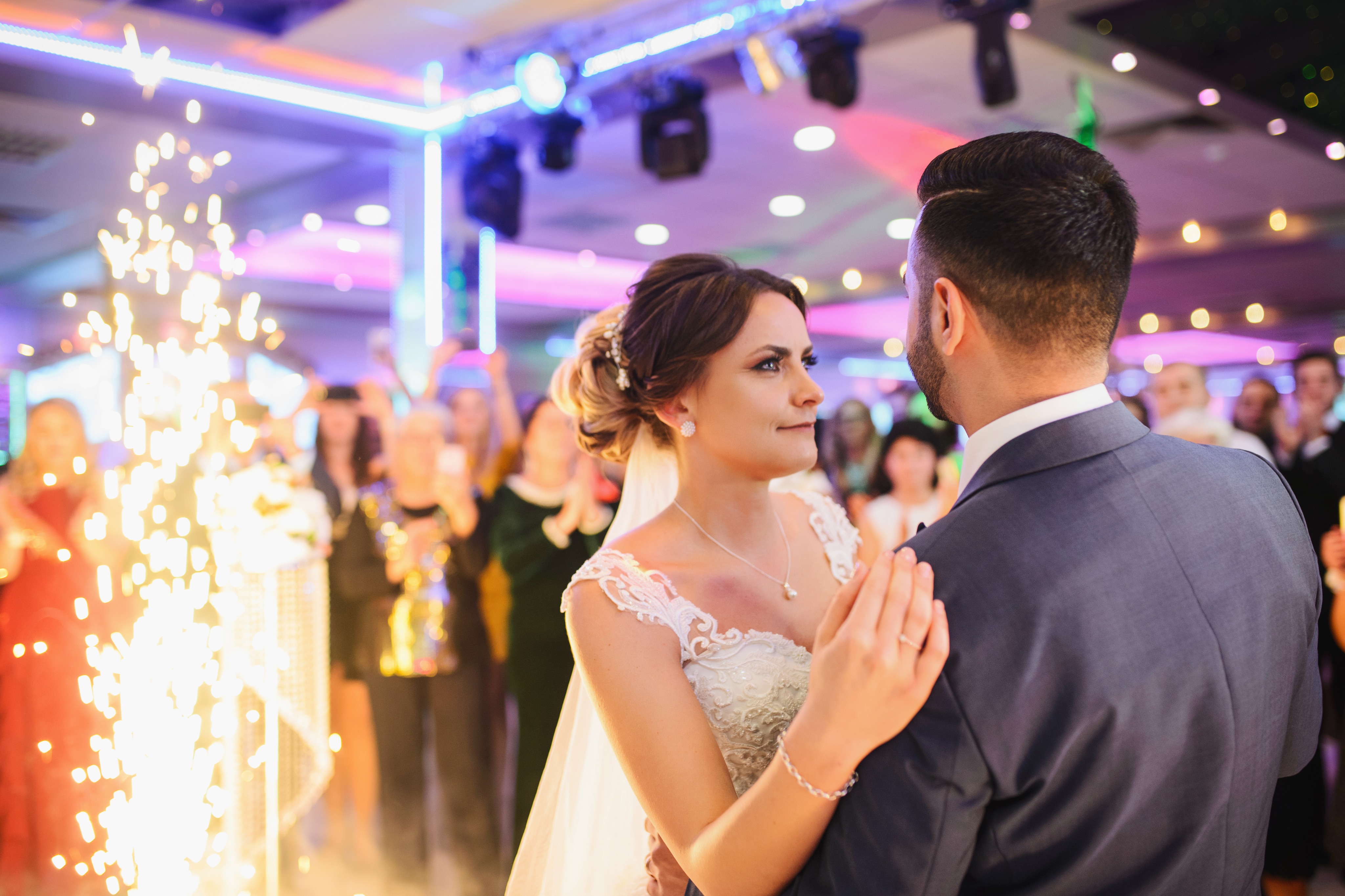 A couple's first dance surrounded by friends and family