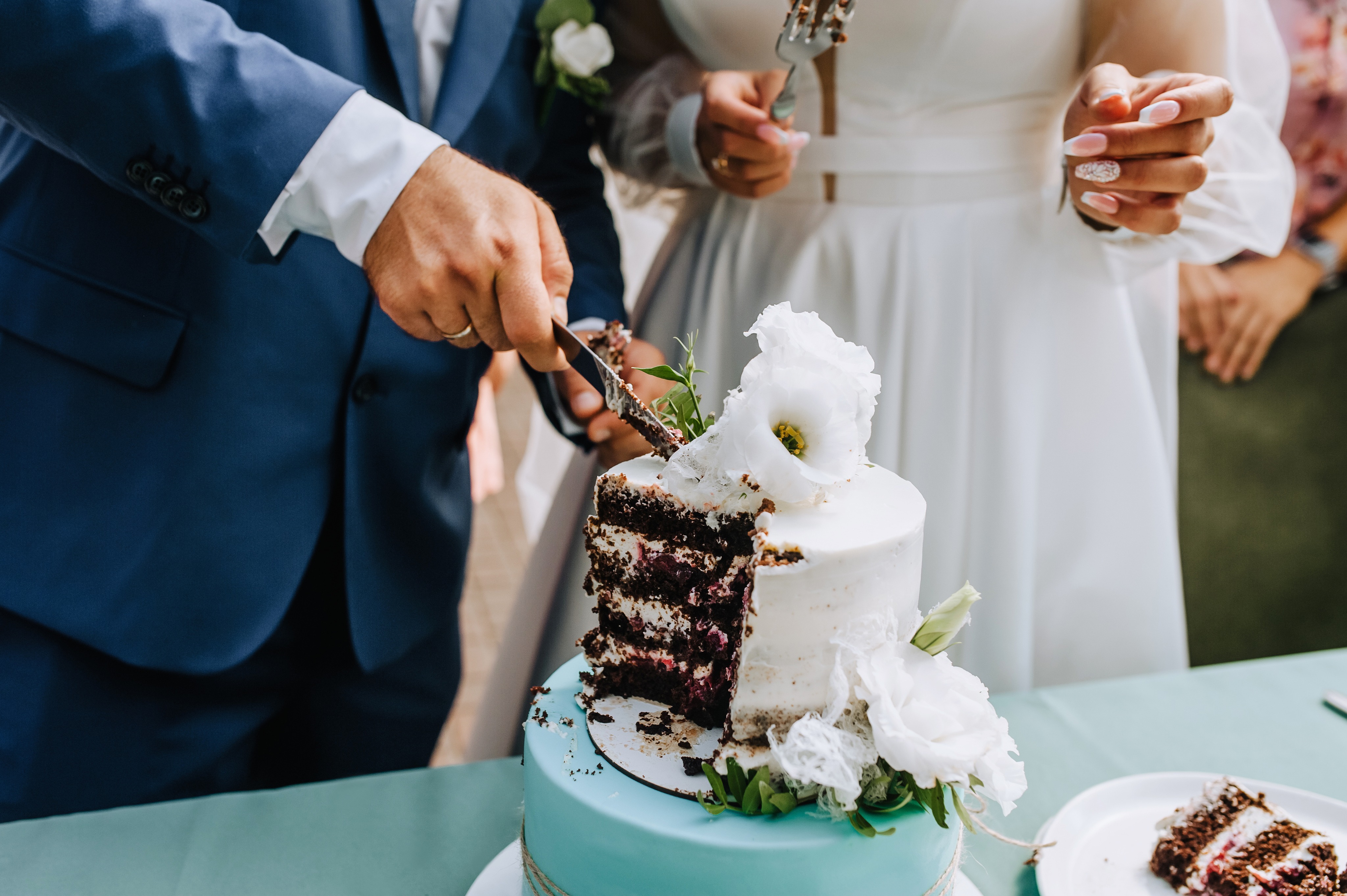 Cake cutting and laughter at a wedding reception